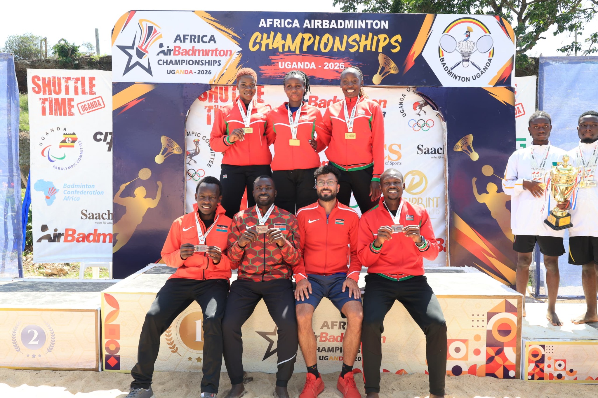 Kenya's AirBadminton medallists with Head Coach Brijesh Sonigra on the podium at the 2026 Africa AirBadminton Championships in Uganda